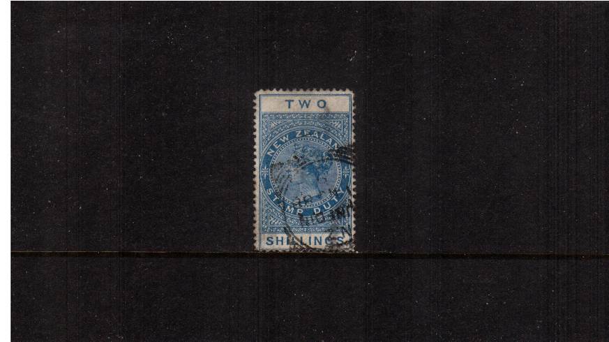 2/- Blue - Perforation 12 Postal Fiscal<br/>
A fine used stamp cancelled with a DUNEDIN ''squared circle'' cancel
<br/><b>QSQ</b>